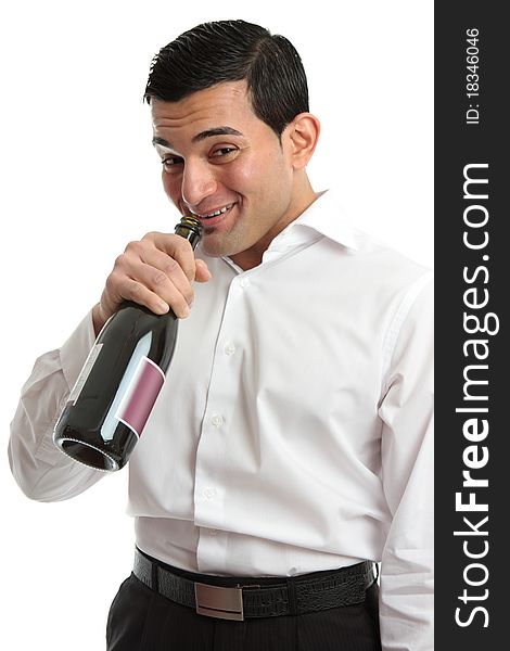 A tipsy or drunk man party goer drinking directly from a wine bottle. A tipsy or drunk man party goer drinking directly from a wine bottle