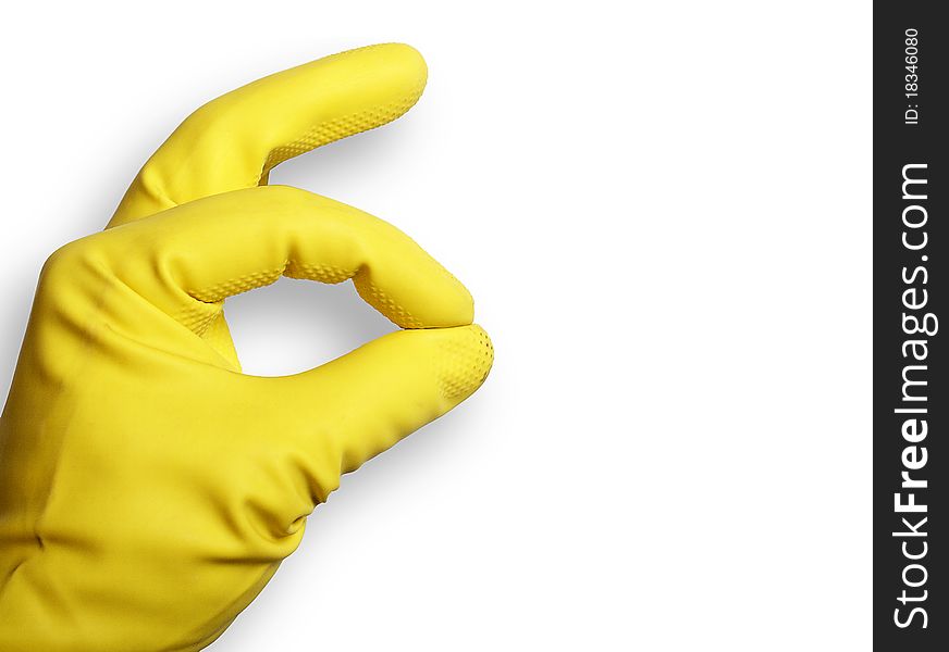 The image shows a human hand with a rubber glove over white. The image shows a human hand with a rubber glove over white