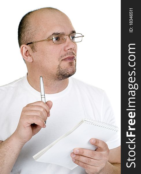 The man writes in a notebook on a white background