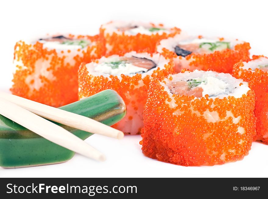 Sushi with red caviar and the Chinese sticks close up.