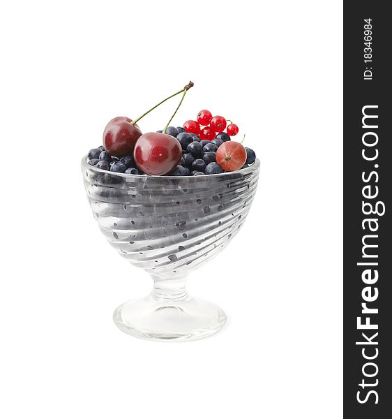 Glass bowl full of fresh delicious berries isolated on white with clipping path. Glass bowl full of fresh delicious berries isolated on white with clipping path