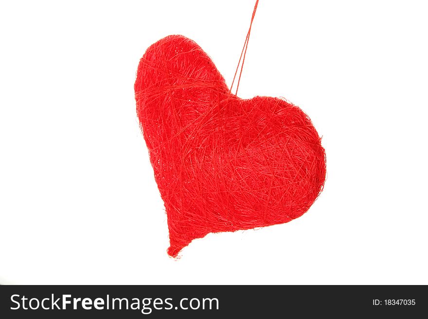 Red heart of the thread isolated on white background