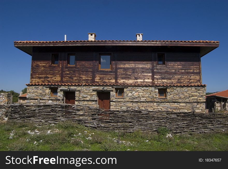 Traditional wooden house in a rural village of Bulgaria. This house house built in the old traditional way of stone and wood. Traditional wooden house in a rural village of Bulgaria. This house house built in the old traditional way of stone and wood