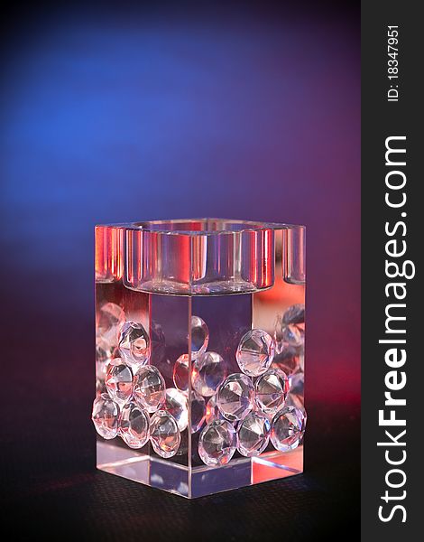 A crystal luxury decorative cube, background shoot with red & blue 
gel