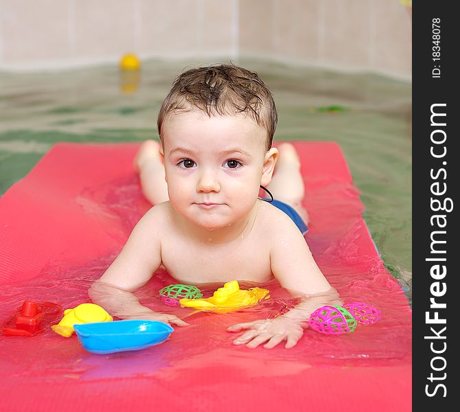 Little happy boy in pool