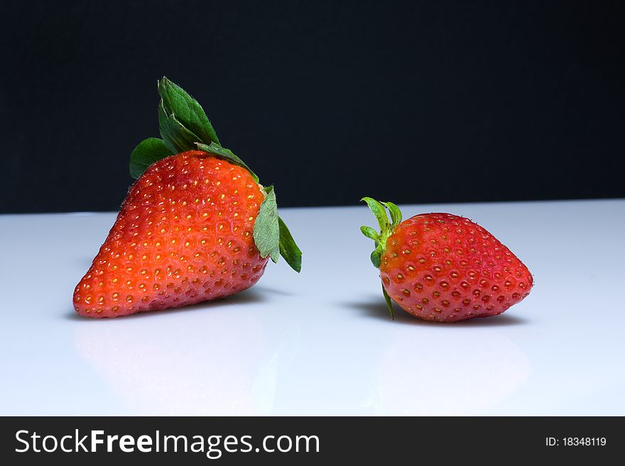 Red strawberries on black and white background