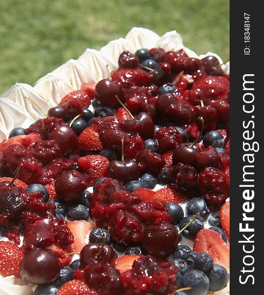 Meringue pavlova with cherries, strawberries and blueberries