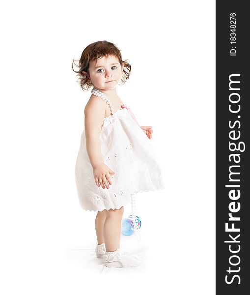 Baby girl in a white dress on a white background