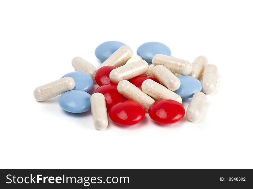 Capsules and pills on white background