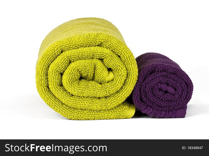 Rolled up green and violet towels