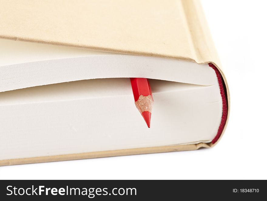 Red pencil on closed book isolated