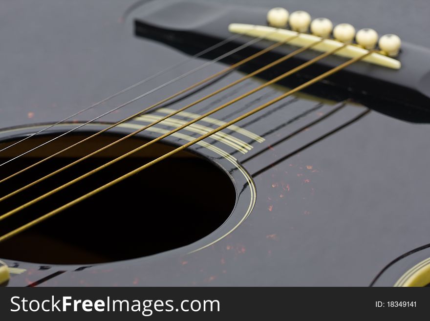 Close-up of strings of a folk guitar