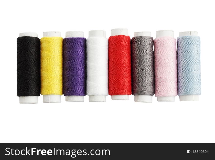 Many colored threads against the white background