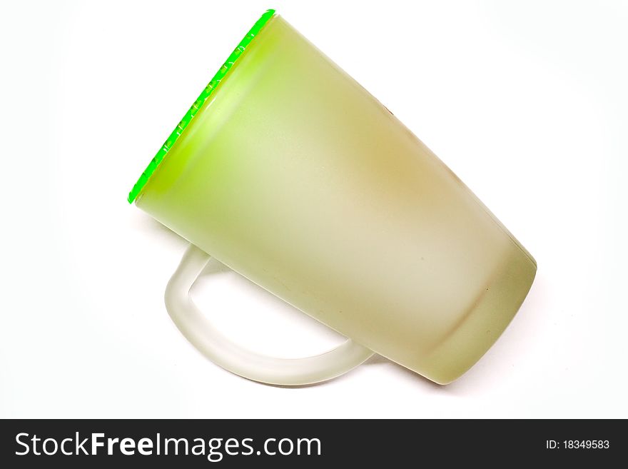 Glass of water on a white background with a green cap