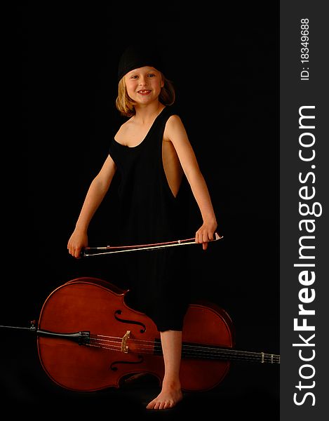 School aged girl with cello on black background. School aged girl with cello on black background