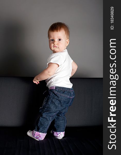 Little Girl Standing On Sofa