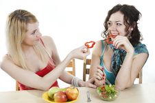Girlfriends Cheerfully Feed Each Other Stock Photos Girlfriends Cheerfully Feed Each Other Stock Photos