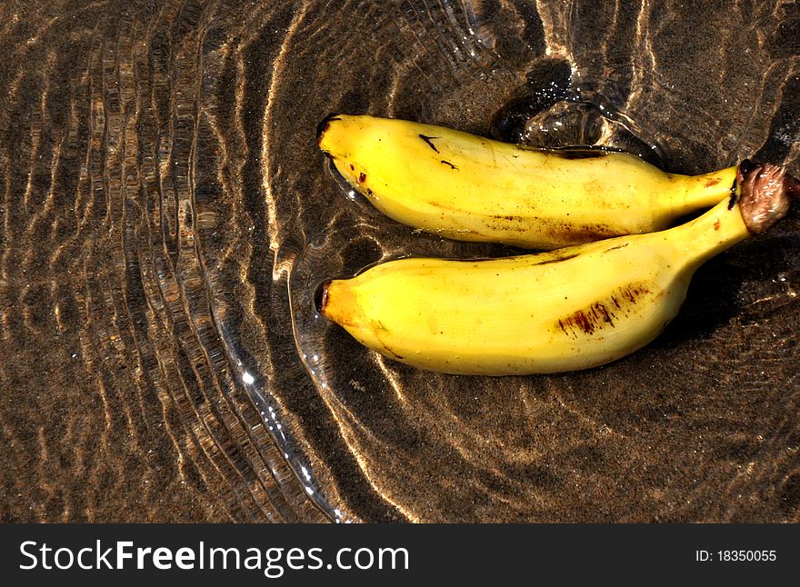 Image shows a pair of banana in water creating wave