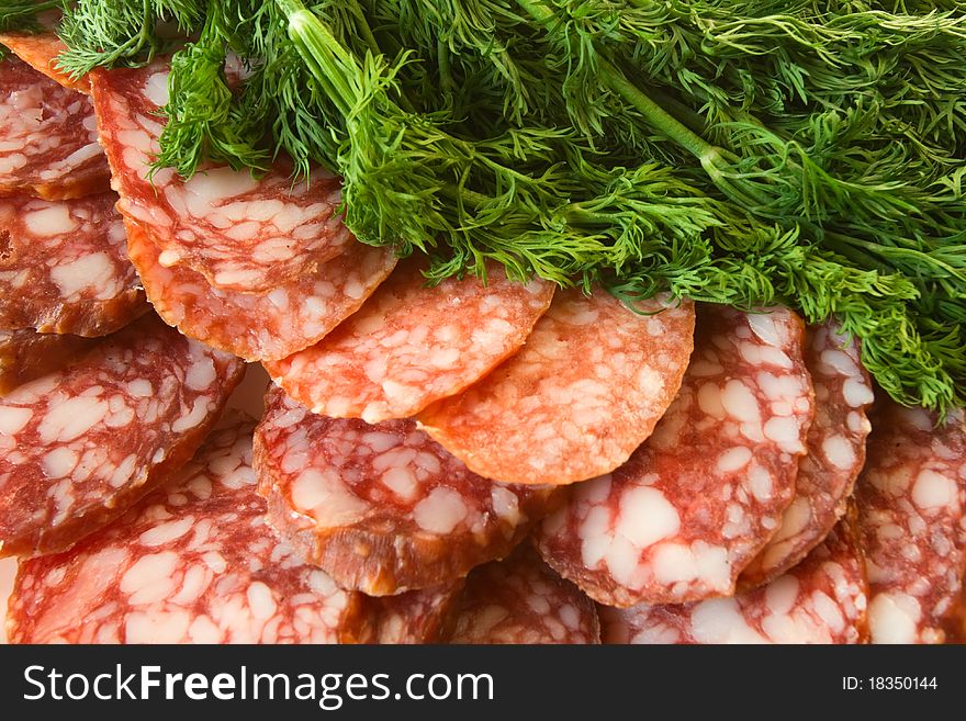 Fresh sausage slices and green dill. Fresh sausage slices and green dill