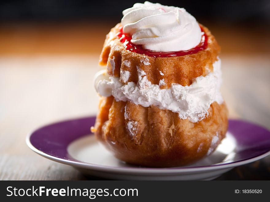 Cream puff drizzled with whipped cream. Cream puff drizzled with whipped cream
