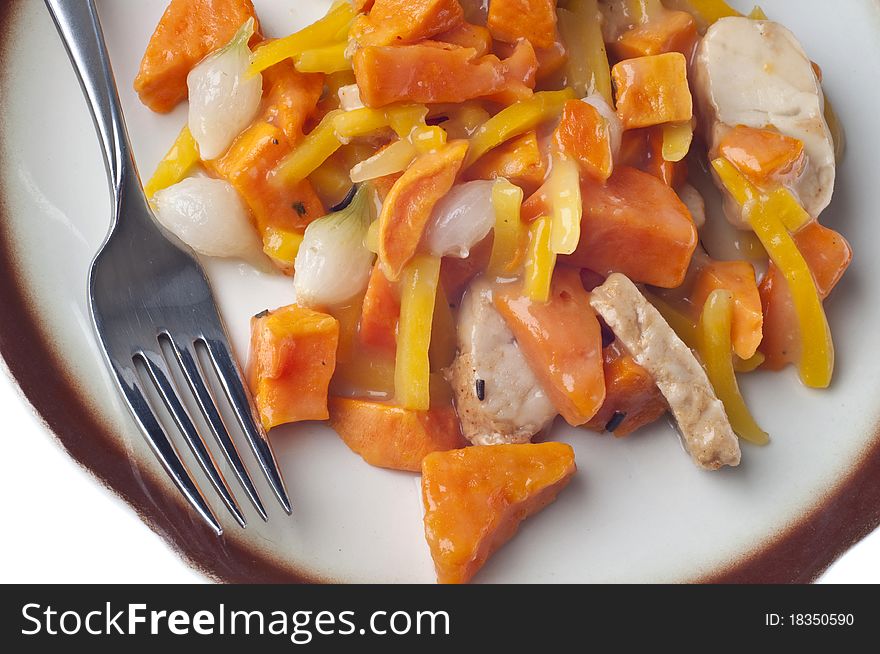 Chicken Sweet Potato and Pearl Onion Dinner with Sauce and Yellow Pepper Slivers.