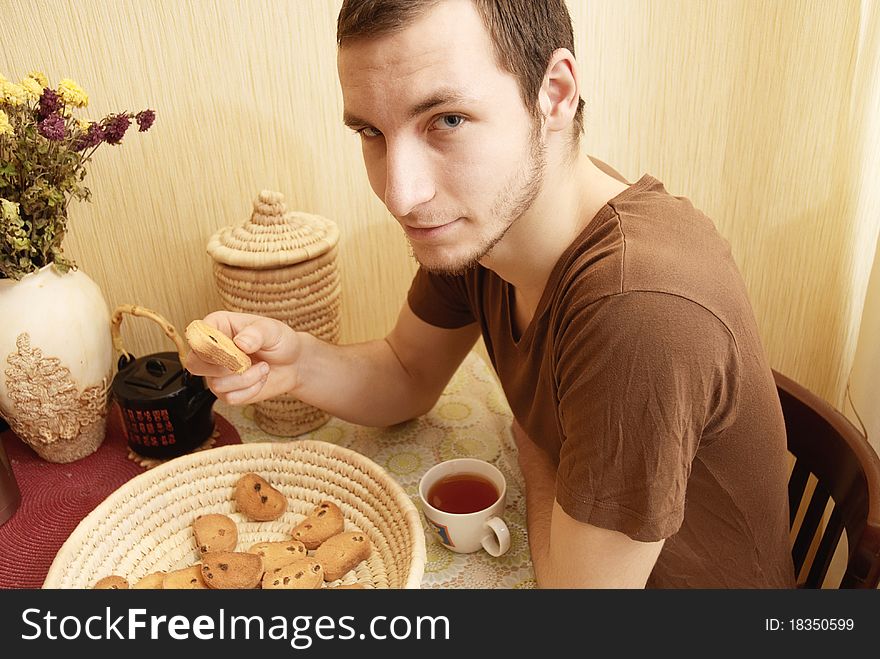 A young guy having a breakfast in the kitchen. A young guy having a breakfast in the kitchen