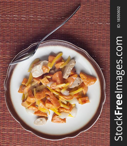 Chicken Sweet Potato and Pearl Onion Dinner with Sauce and Yellow Pepper Slivers.