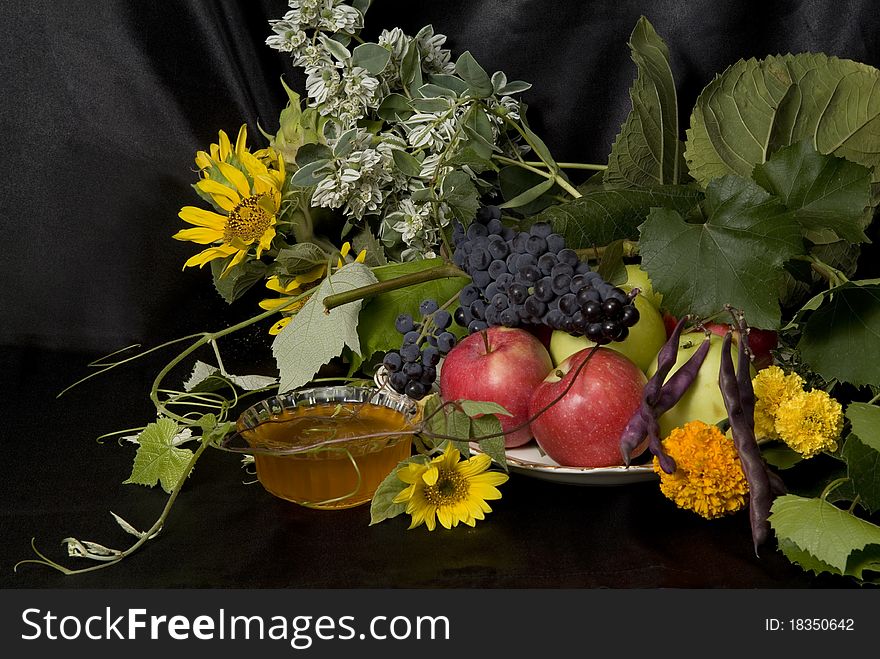 Still life with fruit and honey on a black background after the fall of the Orthodox feast Spas