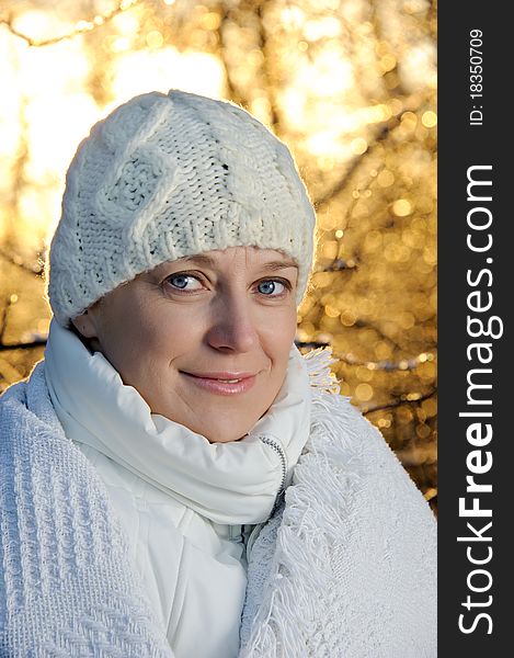 Blue-eyed woman in white in the winter forest. closeup, portrait