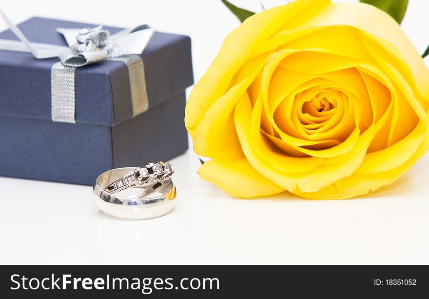 A diamond ring and yellow rose. A diamond ring and yellow rose.