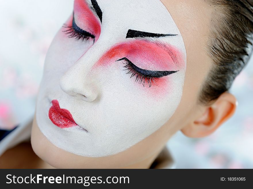 Close-up artistic portrait of japan geisha woman with creative make-up