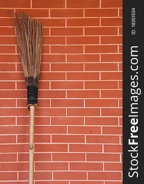 Broom On Brick Wall