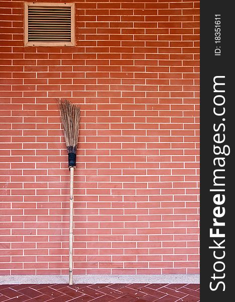 Broom On Brick Wall