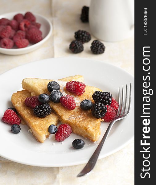 French toasts with fresh berries on a plate. French toasts with fresh berries on a plate