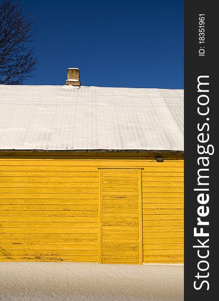 Yellow winter house fragment and snow