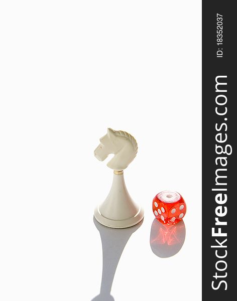 Red dice and white chess knight. Red dice and white chess knight