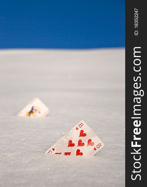 Red hearts cards on snow