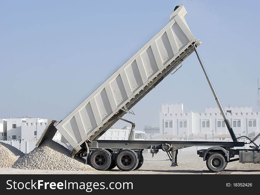 A tipper truck dumping it's load of gravel