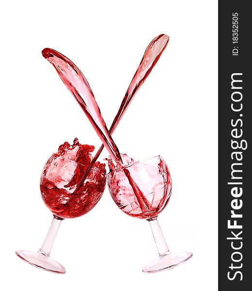Studio photo of splashing red wine glasses.Isolated on white background. Studio photo of splashing red wine glasses.Isolated on white background