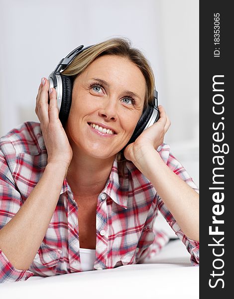Woman listening music with headphones. Woman listening music with headphones