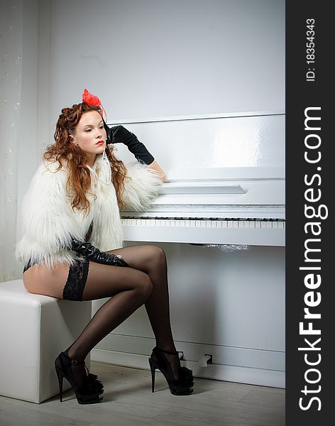 Sexy woman near white piano