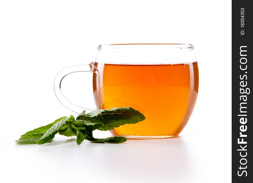 Glass cup of fresh tea with mint leaves