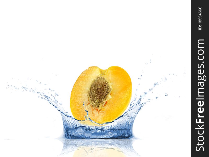 SLice of apricot falling into water, isolated on white background. SLice of apricot falling into water, isolated on white background