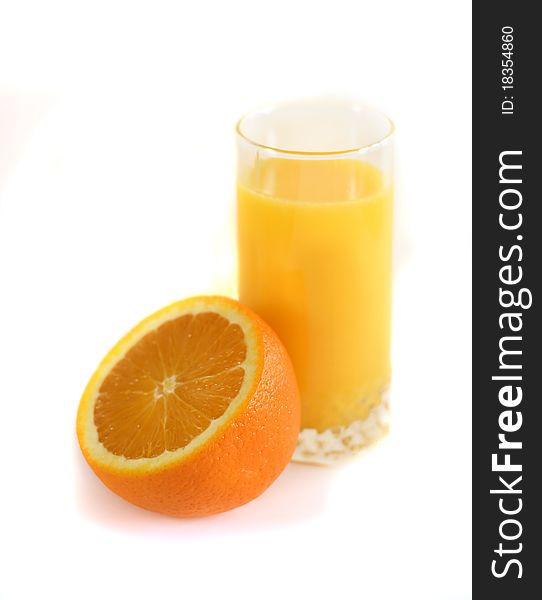 Half an orange and a glass of juice. White background. Half an orange and a glass of juice. White background.