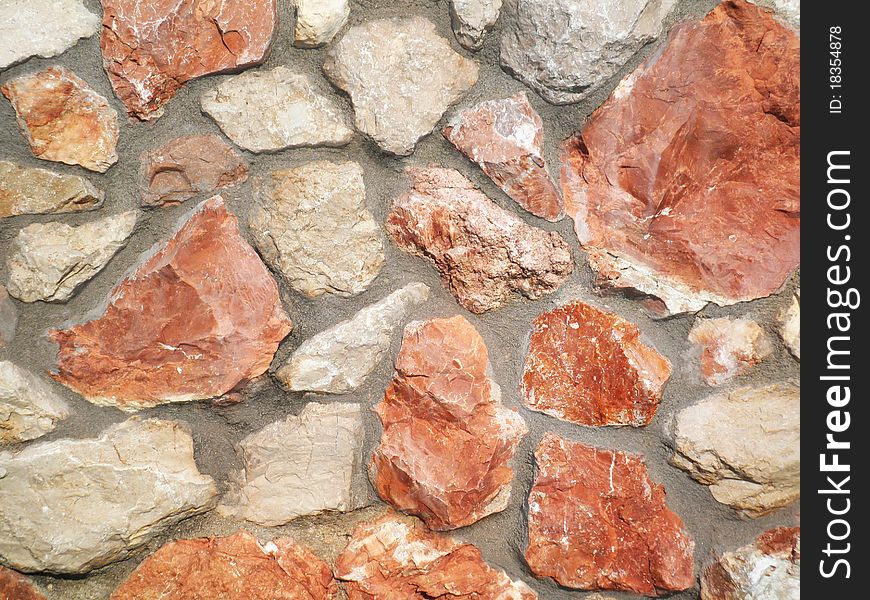 A stone wall made of red and white of the Crimean stone