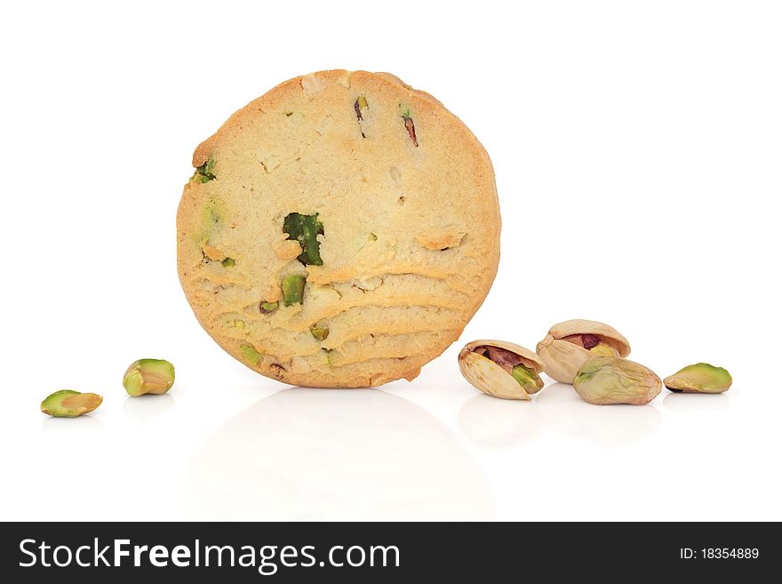 Pistachio biscuit with scattered nuts to one side, over white background. Pistachio biscuit with scattered nuts to one side, over white background.