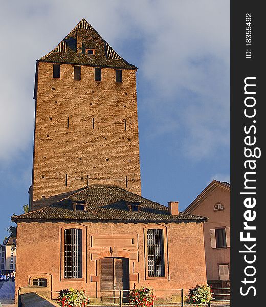 High brick tower in the old part of Strasbourg. Alsace. France. High brick tower in the old part of Strasbourg. Alsace. France