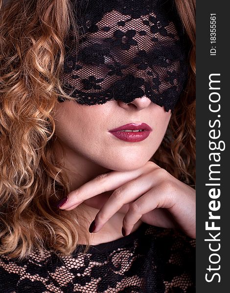 Beautiful woman with red lips and lace mask over her eyes. Beautiful woman with red lips and lace mask over her eyes.