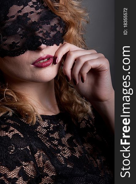 Beautiful woman with red lips and lace mask over her eyes. Beautiful woman with red lips and lace mask over her eyes.