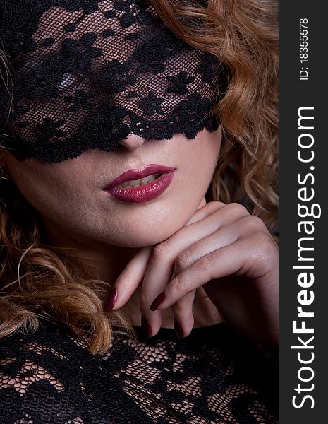 Beautiful woman with red lips and lace mask over her eyes. Beautiful woman with red lips and lace mask over her eyes.